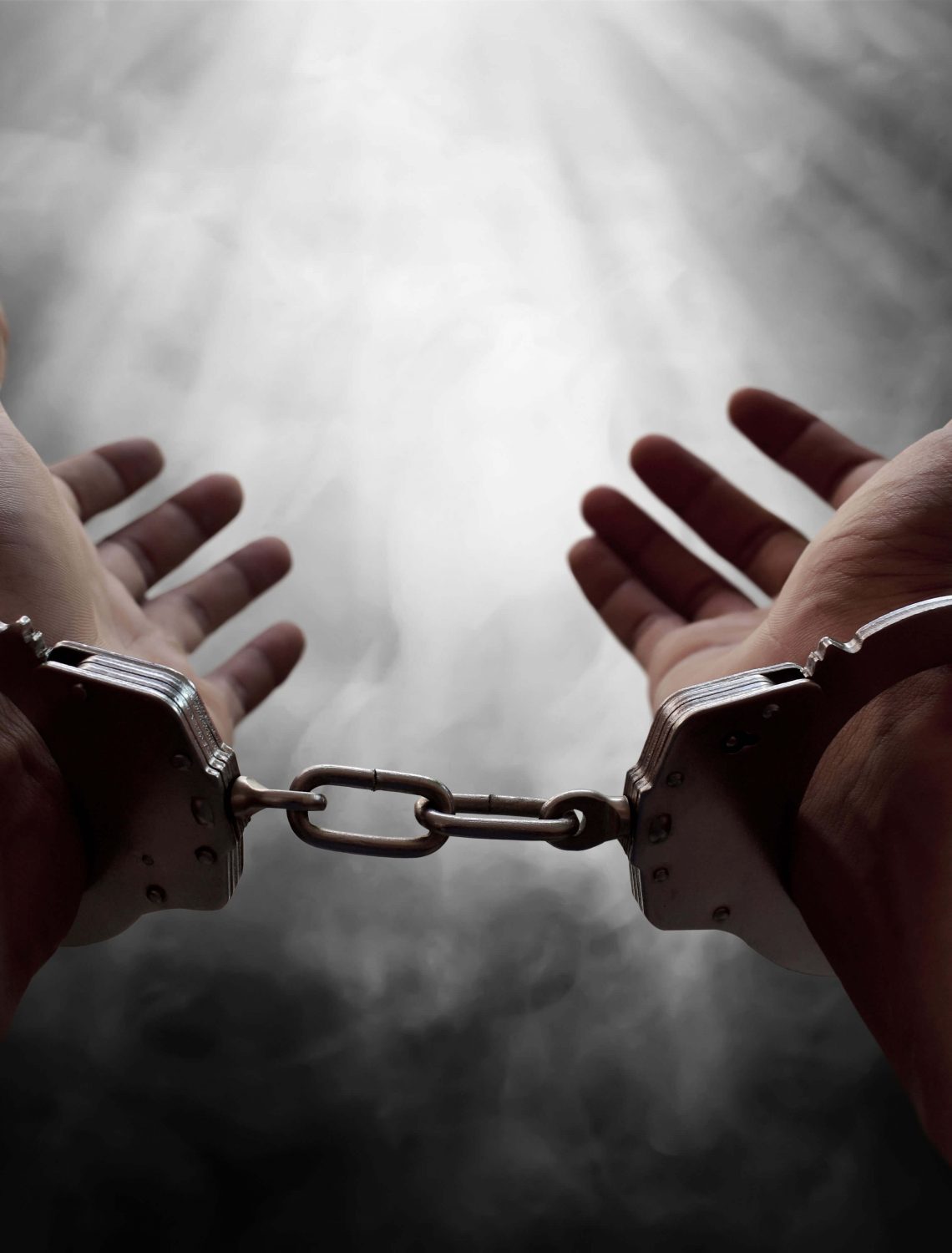Hands of prisoner in handcuffs